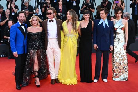 Some of the main cast from Don’t Worry Darling pose for a photo on the red carpet at the 2022 Venice International Film Festival. From left to right: Nick Kroll, Florence Pugh, Chris Pine, Olivia Wilde, Sydney Chandler, Harry Styles, Gemma Chan. (Stephanie Cardinale - Corbis/Corbis via Getty Images) 
