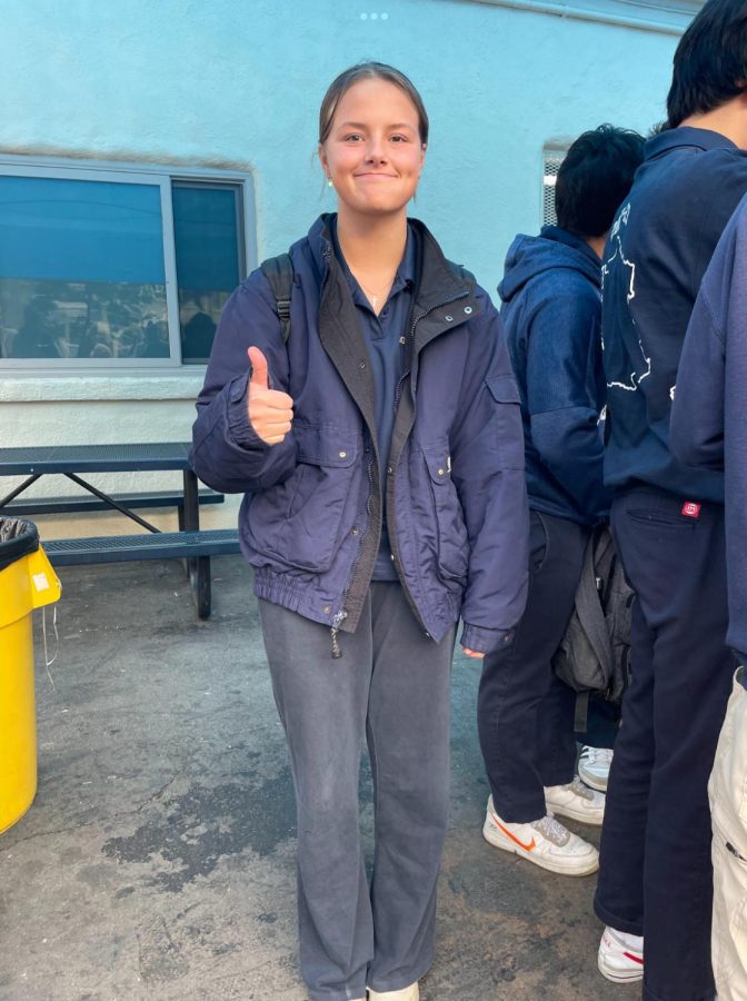 Asher Rawlins ‘24 poses in the jacket that nearly got her dress coded in early December.