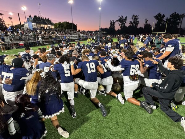 Players for the Notre Dame and Birmingham Charter football teams pray together on the field after a player was injured during Fridays game at Notre Dame High on Friday, Aug. 25. (Photo by Dan Lovi)