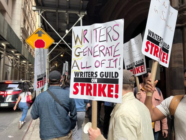 Writers, actors, and supporters on the picket line in New York carry protest signs to fight for their demands.